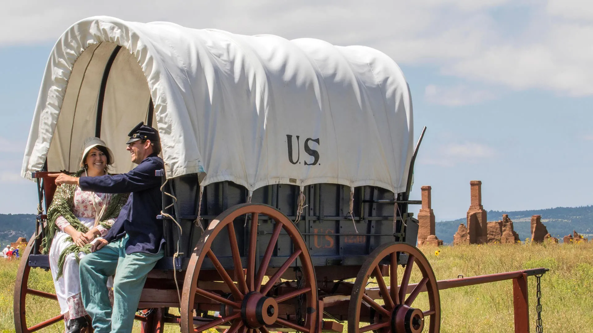 Reenactors sitting on cart at Fort Union National Monument