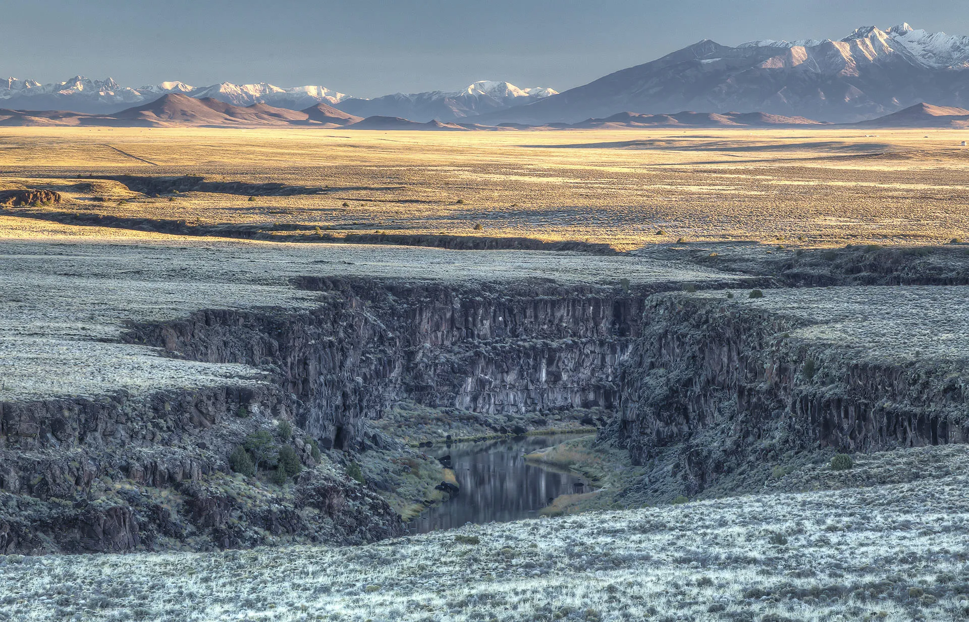 Rio Grande river valley stretches out with mountains in background