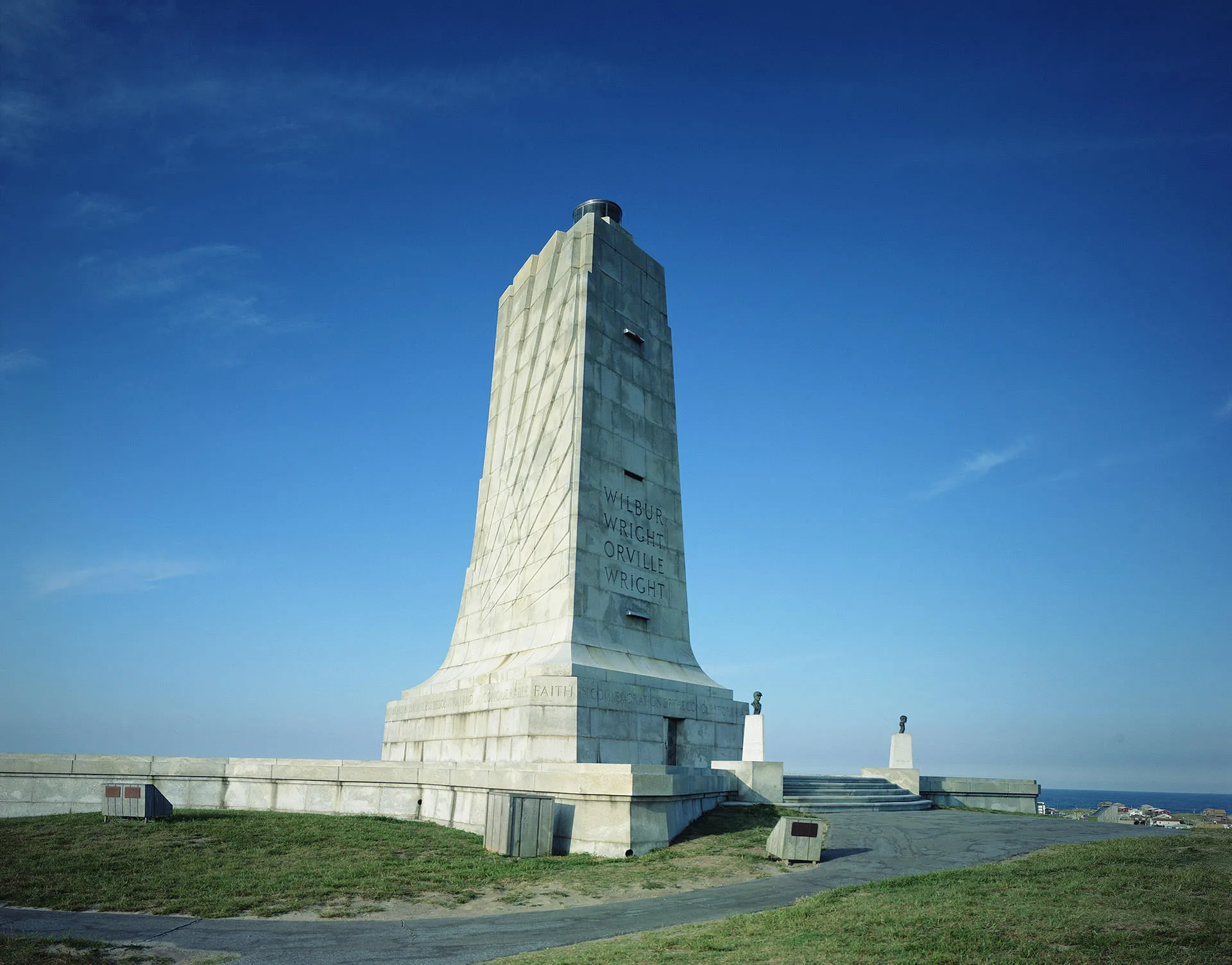 Image of granite-made Wilbur and Orville Wright Memorial with blue sky