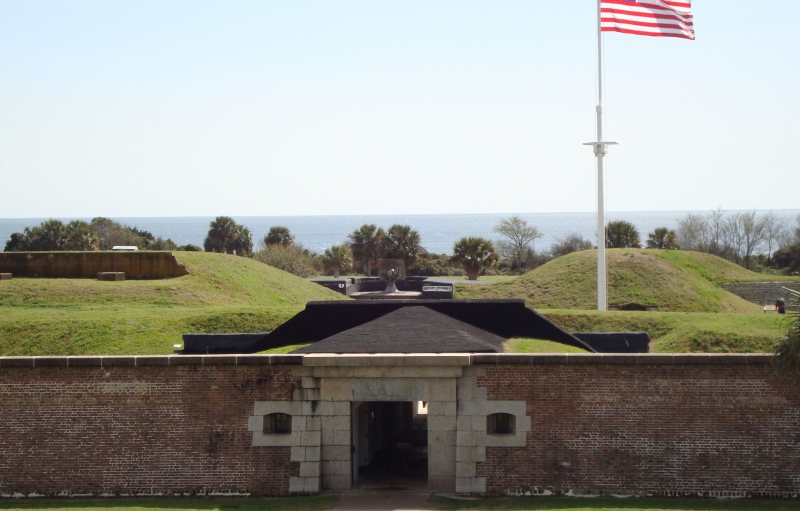 Brick fort entrance to Fort Moultrie with a flag waving at the entrance
