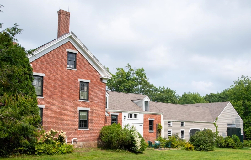 red brick buildings and green trees at the Frances Perkins homestead