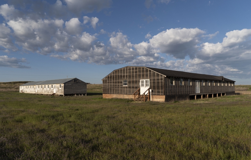 barrack and mess hall with grass and sky