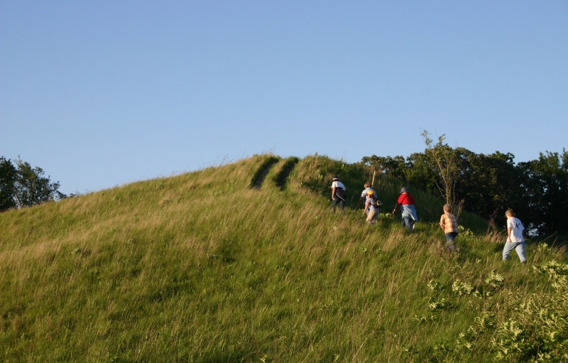 5 people hiking up a trail with blue skies along the Lewis & Clark National Historic Trail