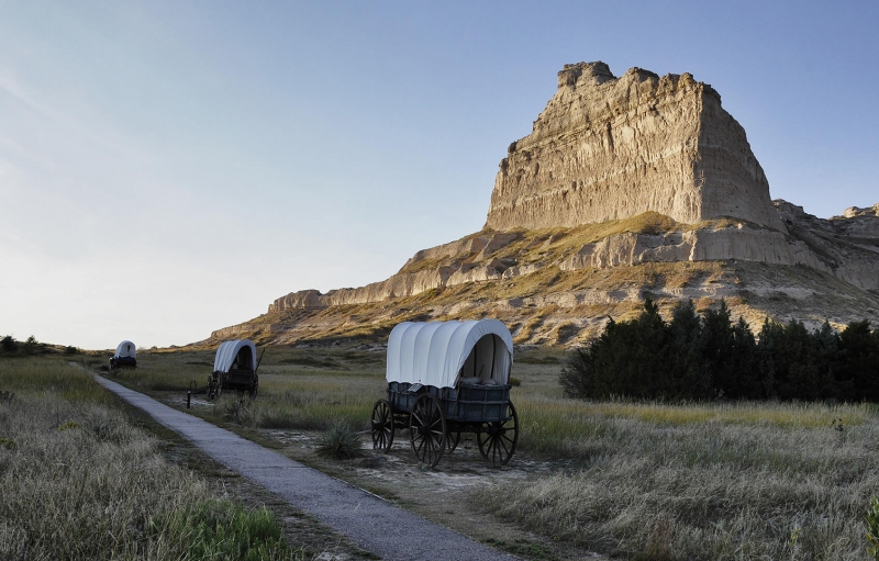 covered wagons in front of mountain