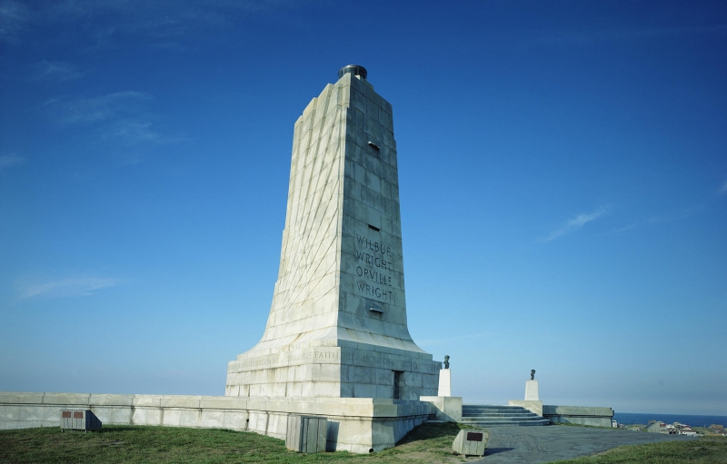 Image of granite-made Wilbur and Orville Wright Memorial with blue sky 