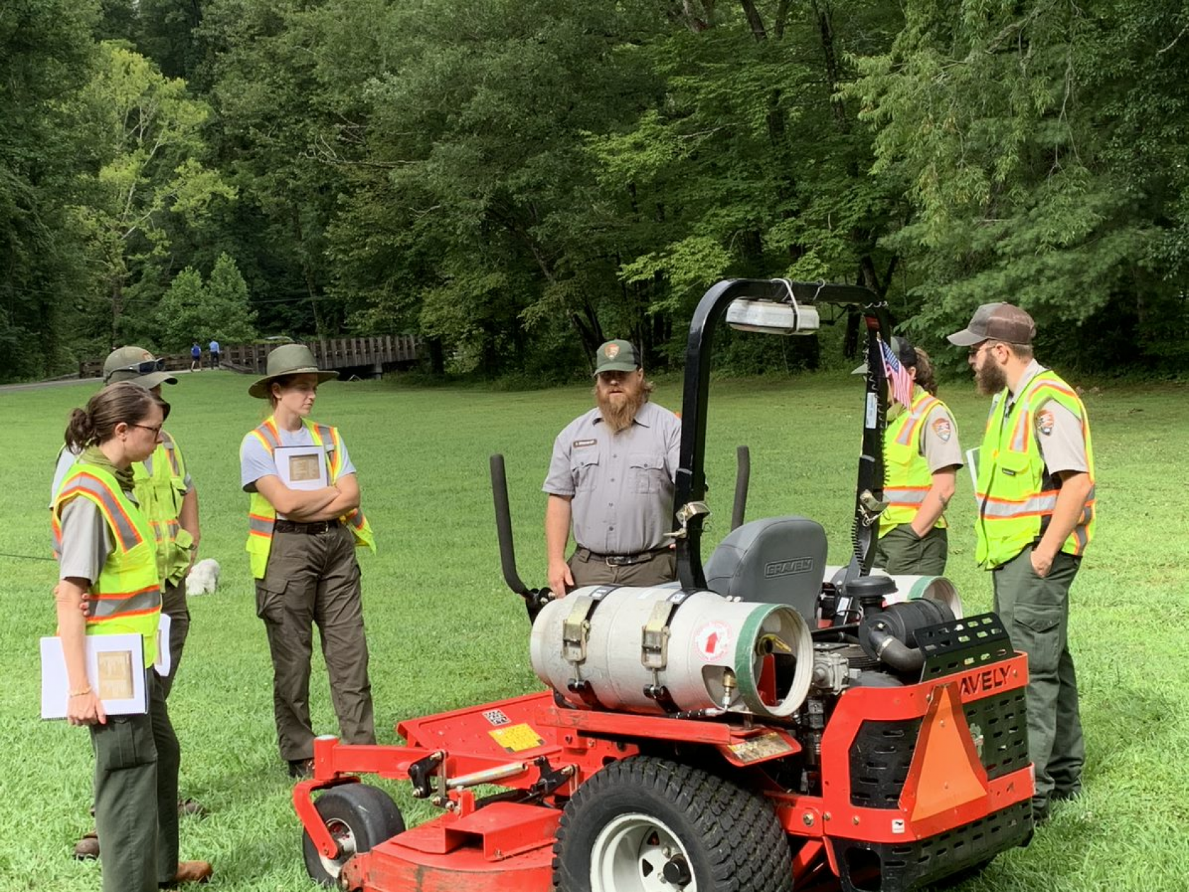 Darin Brinkmeyer and crew gathered around equipment for ground maintenance