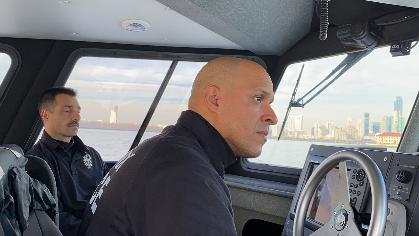 James (driving) and Eddie out on their patrol of the Hudson