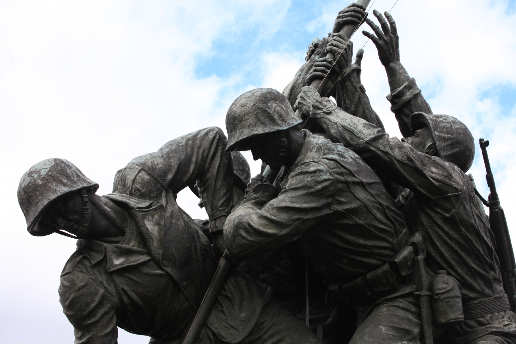 The soldiers lift the flag pole in the U.S. Marine Corps War Memorial