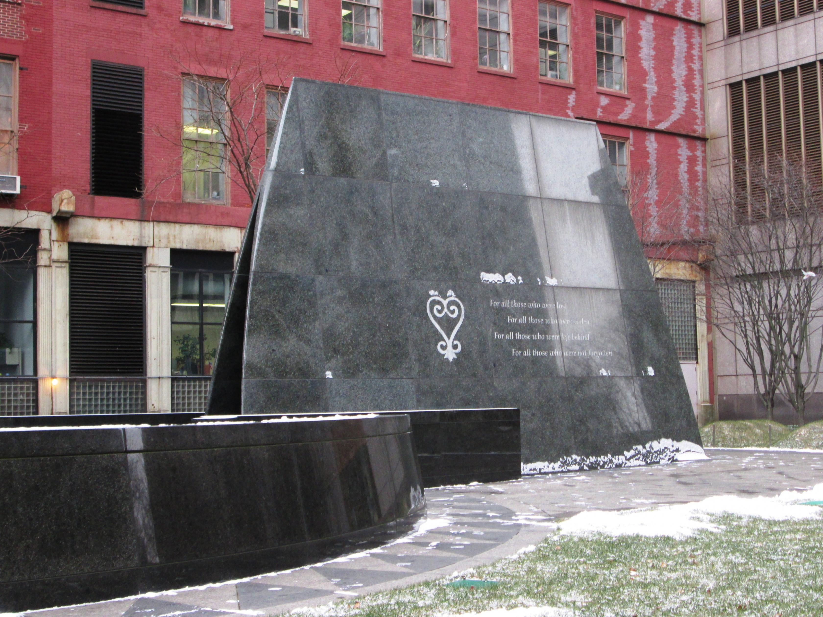 Black marble monument with white inscriptions at the African Burial Ground National Monument