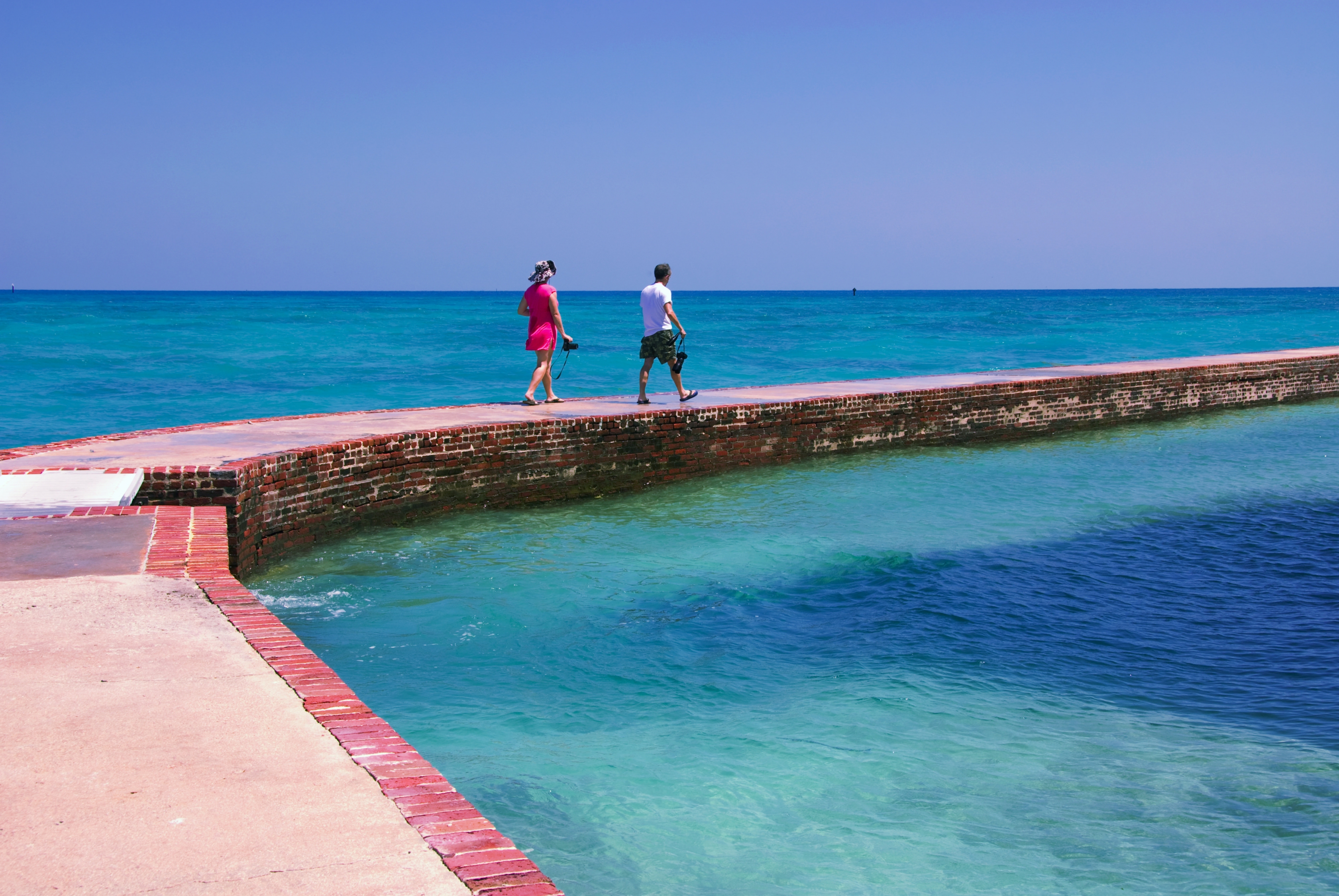 A couple walks along the fort at Dry Tortugas National Park.