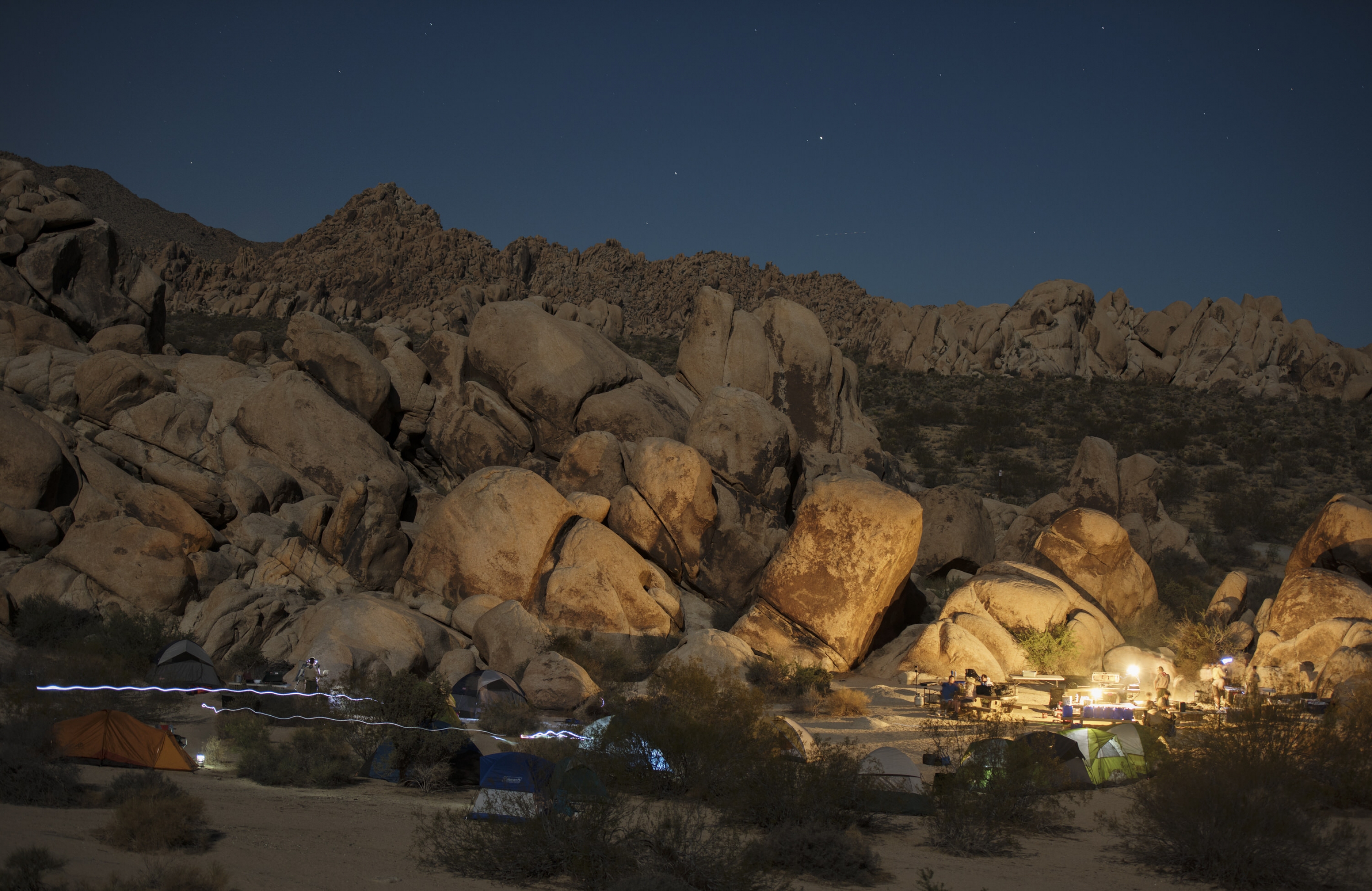 Illuminated campground under a starry night at Joshua Tree National Park
