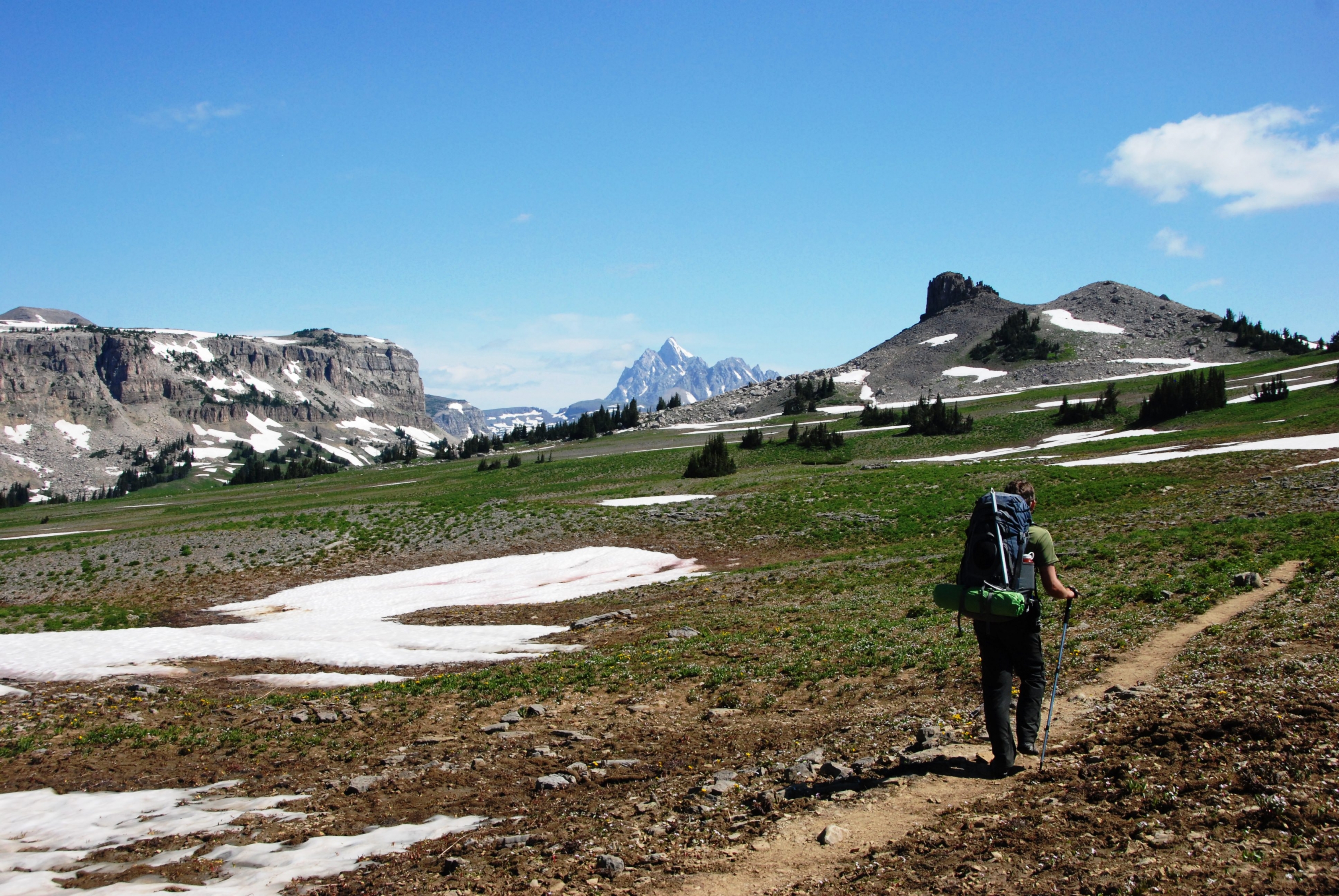 A solo hiker along a crest trail in Grand Teton National Park.