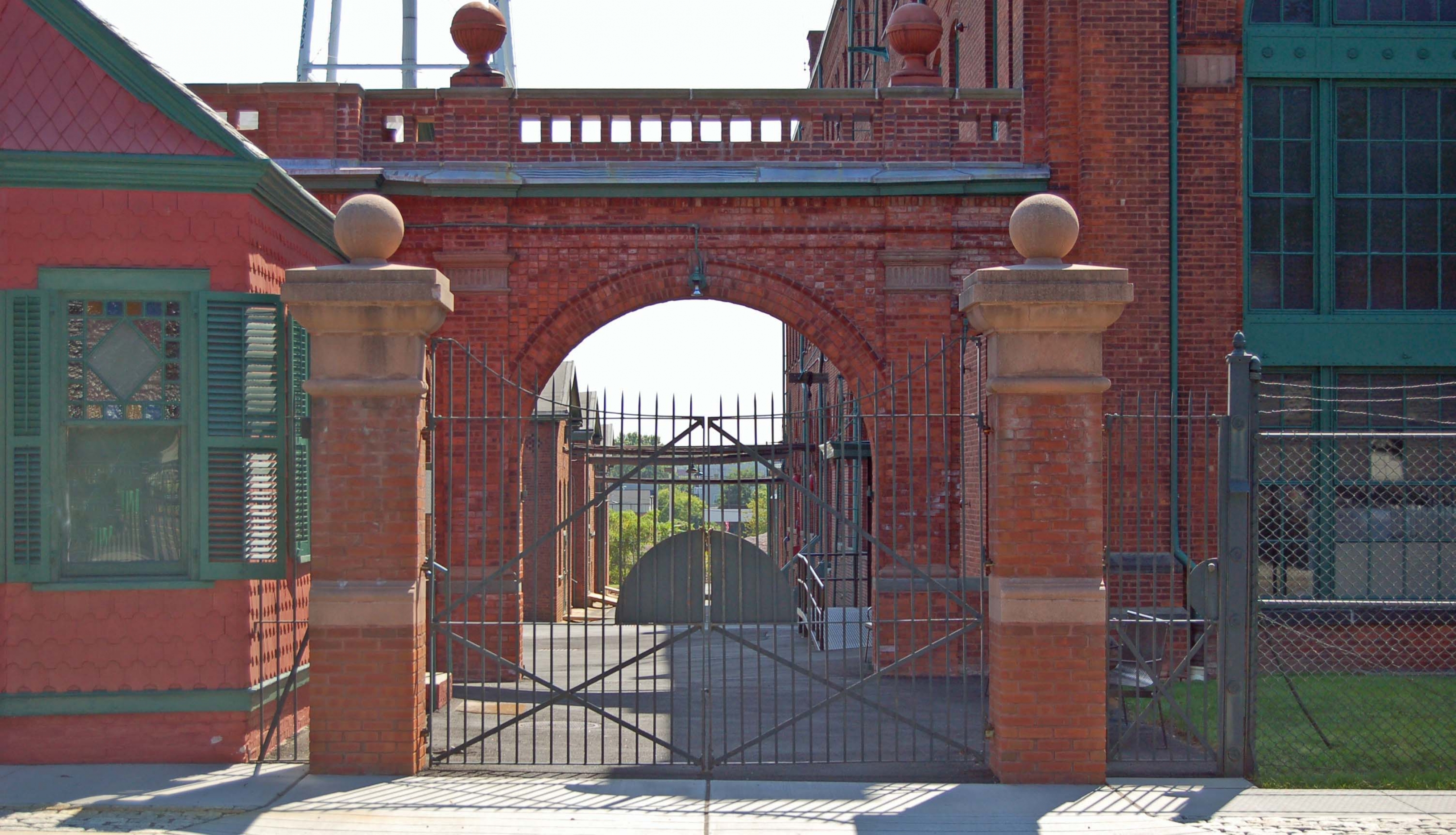 Metal gate entrance fo a red brick and green-windowed building at the Thomas Edison National Historical Park