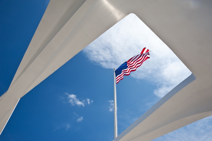 American flag waving in the wind, as seen from below on the USS Arizona Memorial