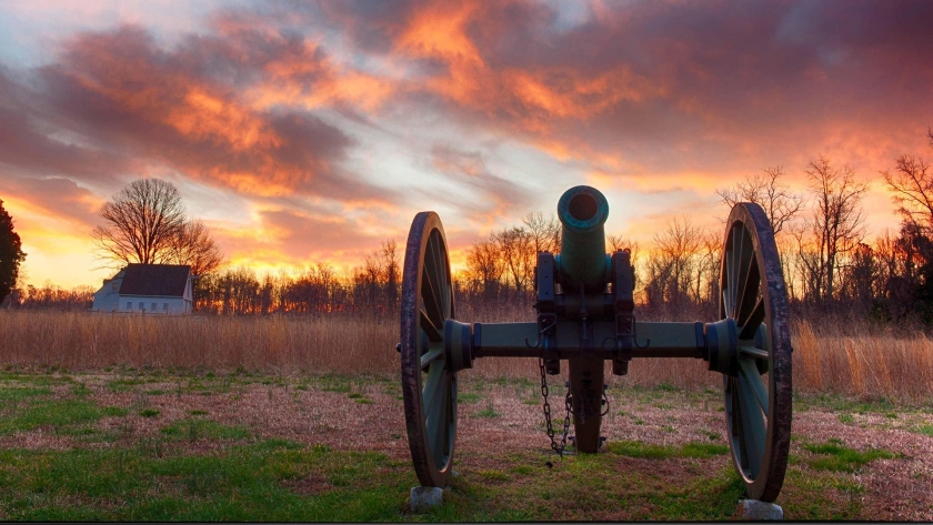 cannon against sunset on battlefield