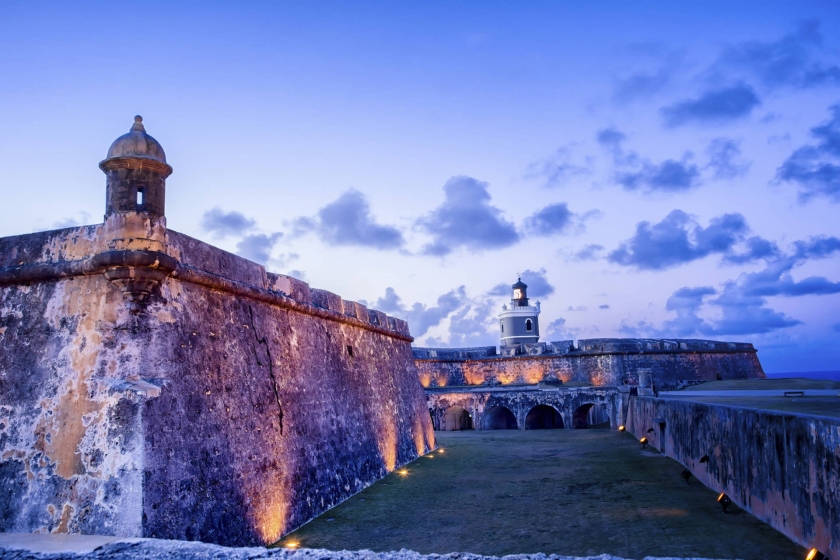 twilight at San Juan, lights shine up on fort walls