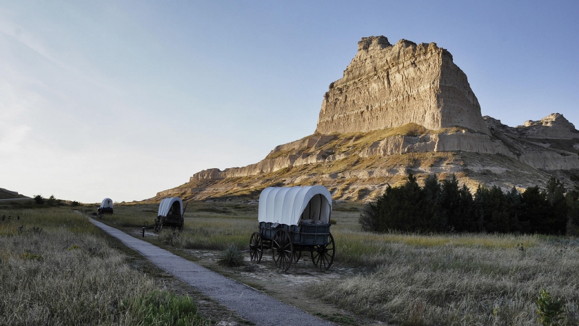 covered wagons in front of mountain
