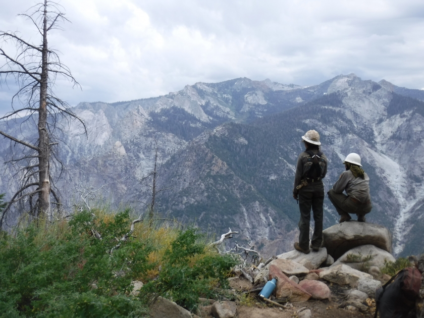 Two people overlooking a valley with mountains in the background at Sequoia & Kings Canyon